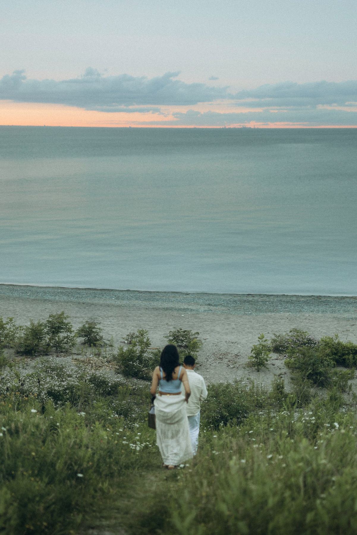 Rutva and Nitin walking down to Lake Ontario at dusk, e-shoot styling by Bhoomi Jani Weddings