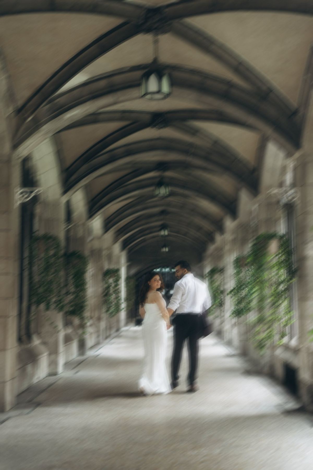 Manpreet and Kanwar walking a vaulted stone cloister in Toronto, e-shoot styling and creative direction by Bhoomi Jani Weddings