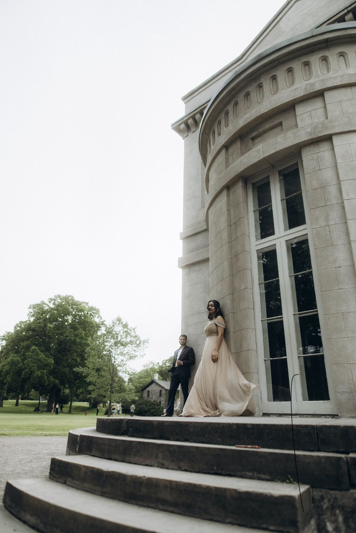 Rutva and Nitin against the stone rotunda of a Toronto estate, e-shoot styling and creative direction by Bhoomi Jani Weddings