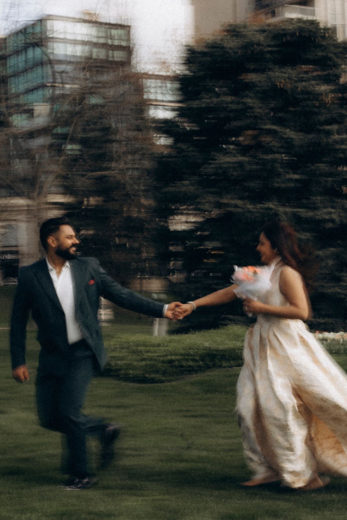 U and S running hand in hand through a Toronto park, e-shoot styling by Bhoomi Jani Weddings